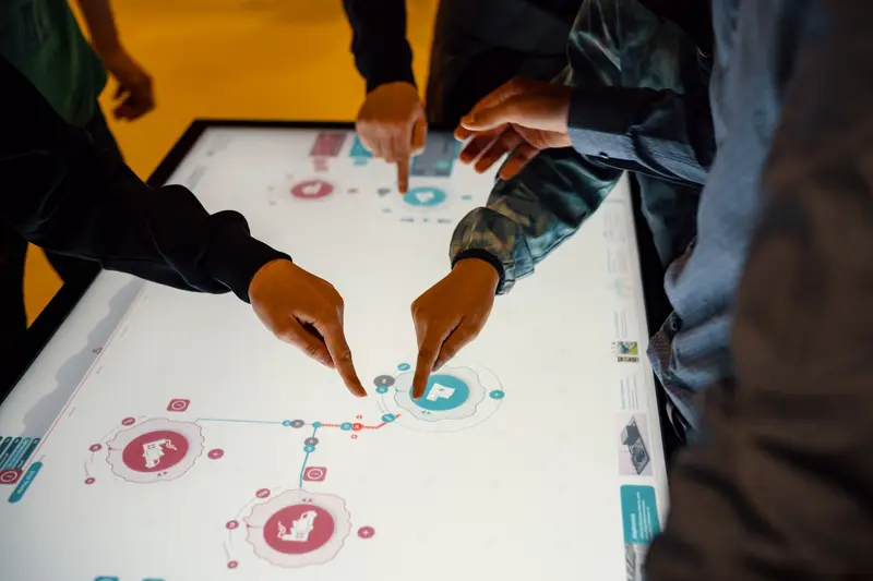 Das Bild zeigt, wie Kinder am Bildschirm das optimale Stromnetz bauen.